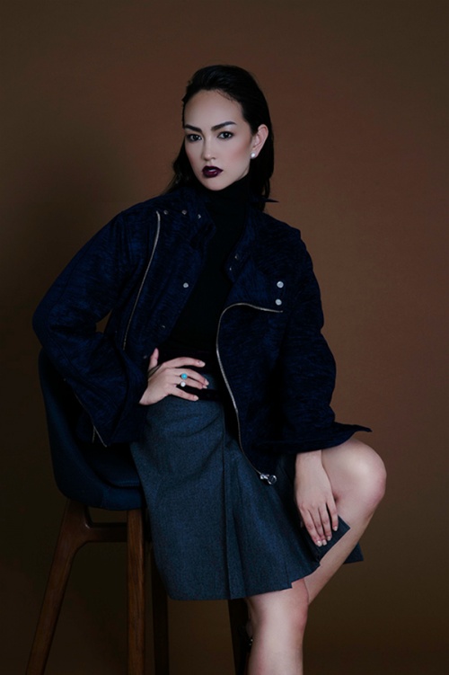 Jessica C wears coat, sweater and skirt by Carven and jewellery by Van Cleef & Arpels